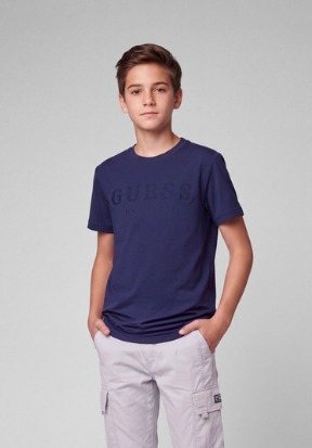 Boy in a navy Guess tee